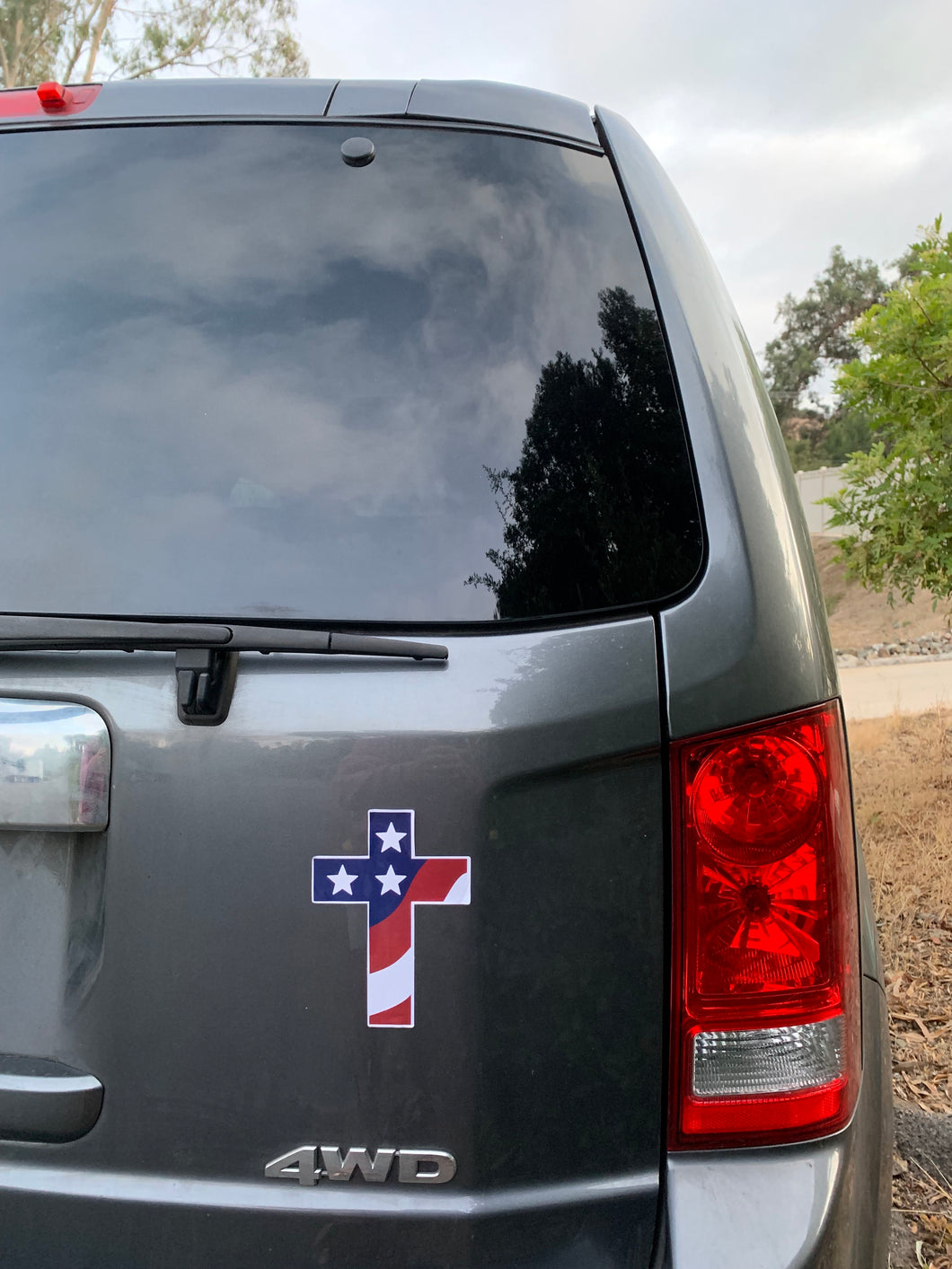 Cross sticker embellished with waving American flag